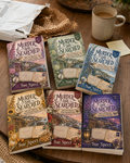 Murder, She Searched: The Complete Postcard Set bundle image showing the complete Murder, She Searched mystery word search paperback set
